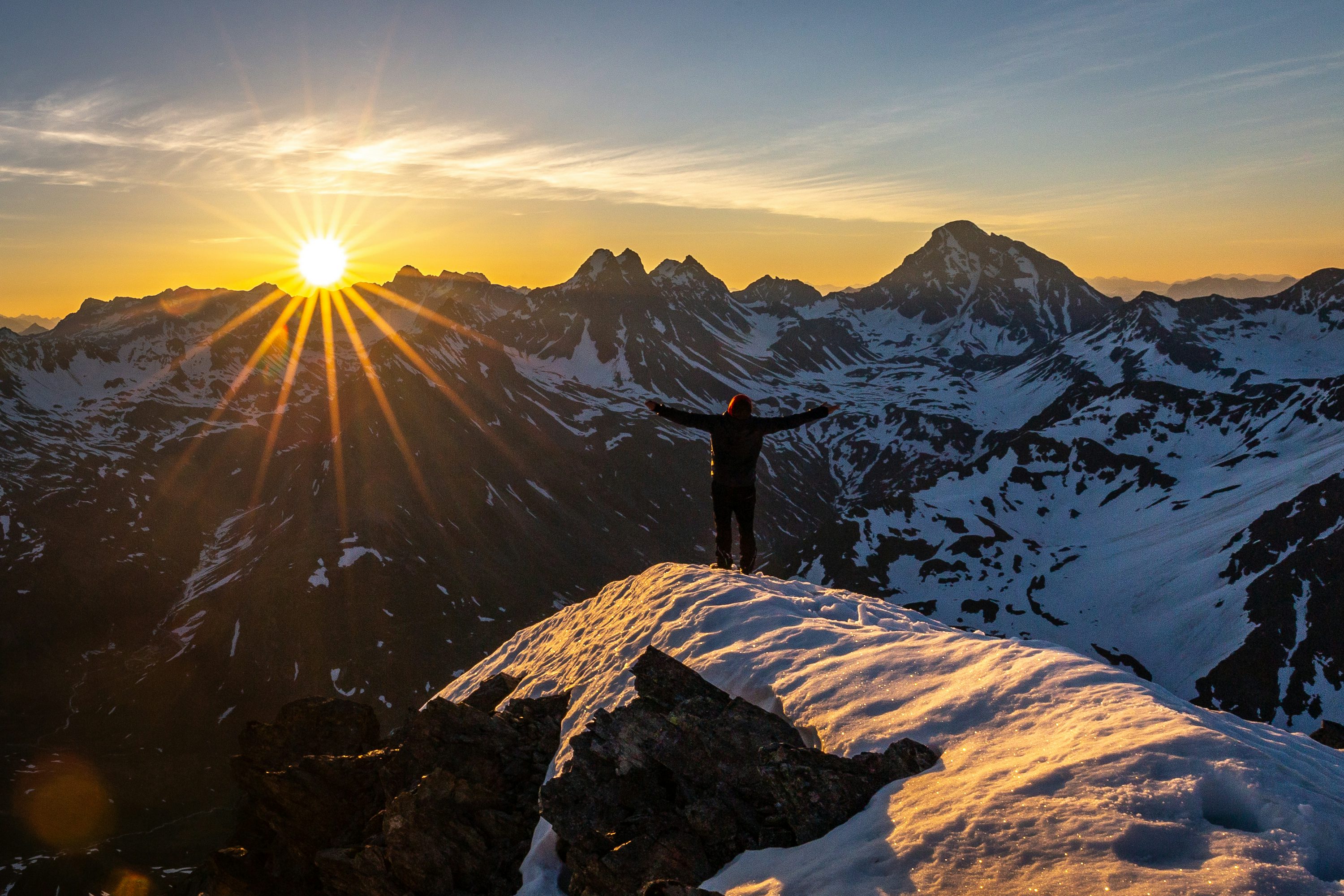 Person standing on hilltop overlooking landscape, representing retirement freedom